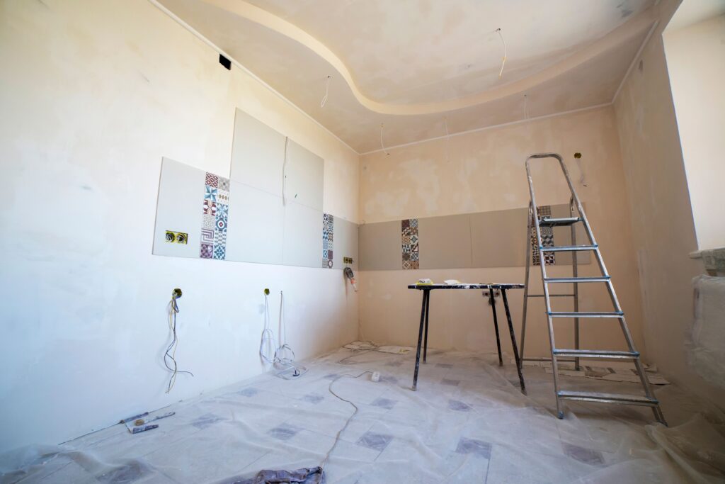 pexels-photo-36035072-36035072 Interior view of a room under renovation with paint, tiles, and tools.